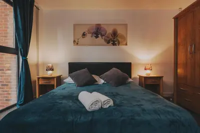 a bedroom with a bed with two towels on it at Liverpool City Centre Apartments - East Village in Liverpool
