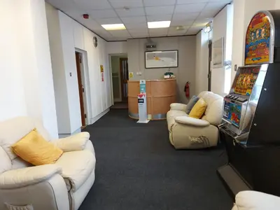 a room with two couches and a video game at The Lodge Guest Accommodation in Barrow in Furness