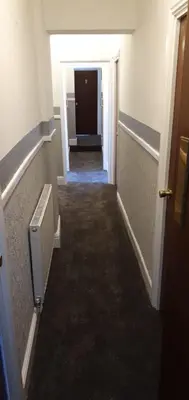 a hallway of an empty room with a hallway at The Lodge Guest Accommodation in Barrow in Furness