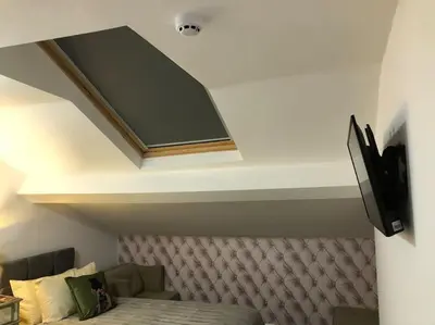 a room with a bed and a tv on the ceiling at Ten Streets Bed & Breakfast in Liverpool