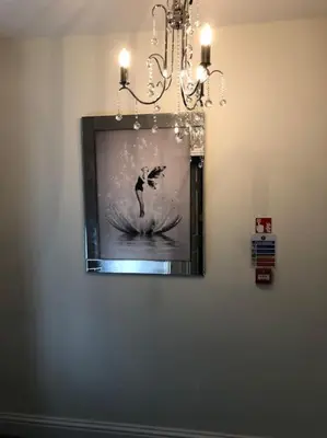 a picture of a woman on a surfboard on a wall at Ten Streets Bed & Breakfast in Liverpool