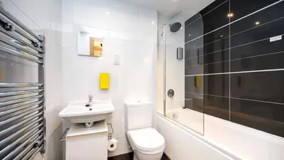 a bathroom with a toilet and a sink and a bath tub at Staycity Aparthotels Liverpool City Centre in Liverpool