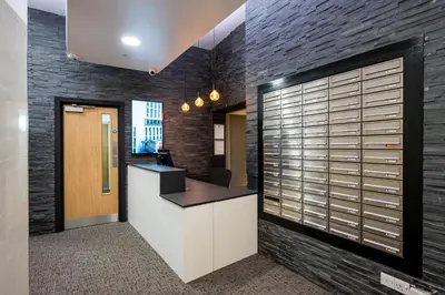 an office lobby with a brick wall at Staycity Aparthotels Liverpool City Centre in Liverpool