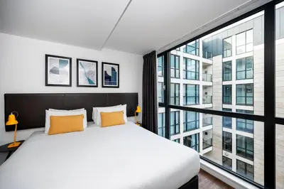 a bedroom with a white bed and a large window at Staycity Aparthotels Liverpool City Centre in Liverpool