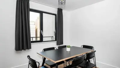 a dining room with a table and black chairs at Staycity Aparthotels Liverpool City Centre in Liverpool