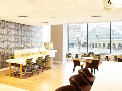 a dining room with tables and chairs and a large window at Holiday Inn Liverpool City Centre by IHG in Liverpool