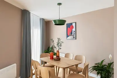 a dining room with a wooden table and chairs at Cove Paradise Street in Liverpool