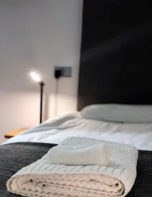 a white towel laying on top of a bed at Seafront419 By Seafront Collection in Blackpool
