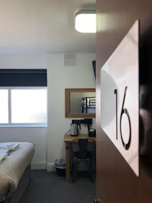 a hotel room with a bed and a desk with a desk at Seafront419 By Seafront Collection in Blackpool