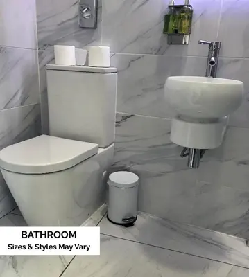 a white bathroom with a toilet and a sink at Seafront419 By Seafront Collection in Blackpool