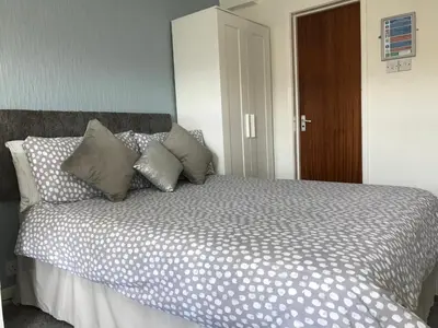 a bed with pillows on it in a bedroom at Brene Hotel in Blackpool