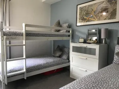 a bedroom with two bunk beds and a desk at Brene Hotel in Blackpool