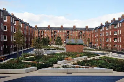 a large brick building with a garden in front of it at Maritime Apartments in Barrow in Furness