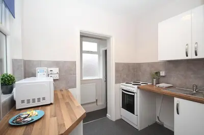 a kitchen with a sink and a stove top oven at Maritime Apartments in Barrow in Furness