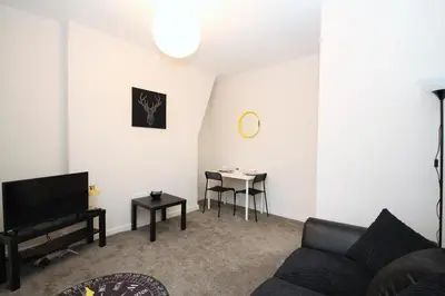 a living room with a couch and a table at Maritime Apartments in Barrow in Furness