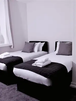 two beds sitting next to each other in a room at Maritime Apartments in Barrow in Furness