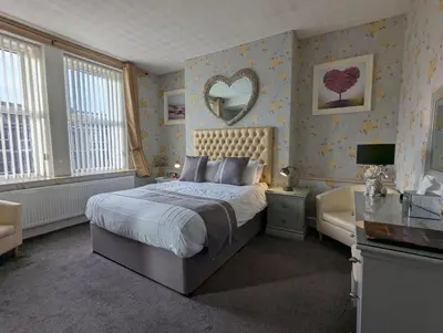 a bedroom with a bed and a mirror on the wall at Valentine Lodge Over 21 Adult Couples Only in Blackpool