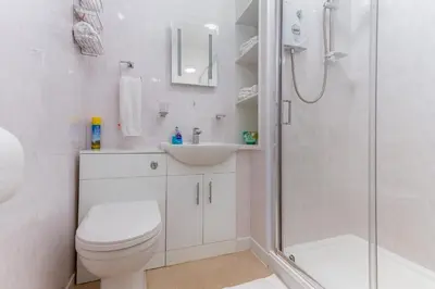 a bathroom with a shower and a toilet and a sink at Valentine Lodge Over 21 Adult Couples Only in Blackpool