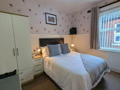 a bedroom with a white bed and a window at Valentine Lodge Over 21 Adult Couples Only in Blackpool