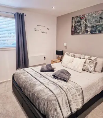 a bedroom with a bed with two pillows on it at Fenna Lakeside Lodge - Pine Lake Resort in Carnforth