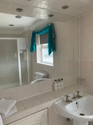 a bathroom with a sink and a mirror at The Old Coach House in Blackpool