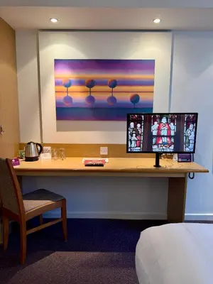 a desk with a computer on it in a hotel room at Premier Nights, Wigan, Standish M6 J27 in Standish