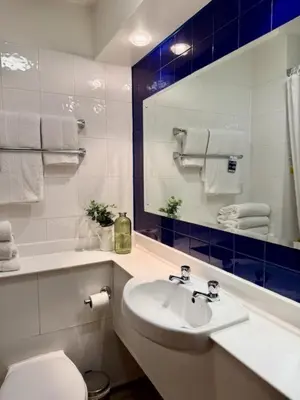 a bathroom with a sink and a toilet and a mirror at Premier Nights, Wigan, Standish M6 J27 in Standish