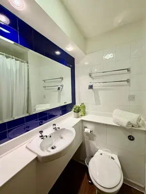 a bathroom with a white toilet and a sink at Premier Nights, Wigan, Standish M6 J27 in Standish
