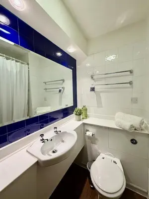 a bathroom with a white toilet and a sink at Premier Nights, Wigan, Standish M6 J27 in Standish