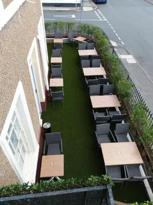 a row of tables and chairs on the side of a building at The Royal Hotel in Liverpool