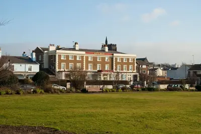 a large building with a grass field in front of it at The Royal Hotel in Liverpool
