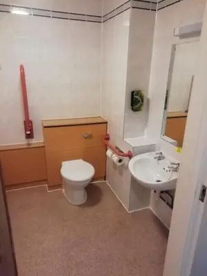 a bathroom with a toilet and a sink at Purple Roomz Preston South in Preston