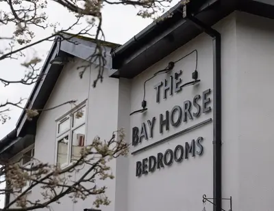 a sign on the side of a building at The Bay Horse Hotel in Haydock