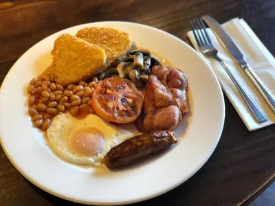 a plate of breakfast food with eggs beans and toast at The Bay Horse Hotel in Haydock