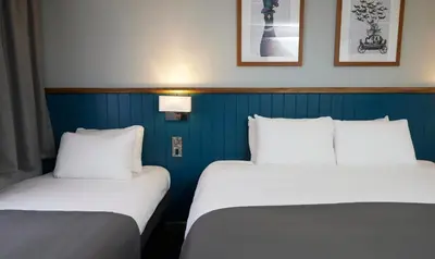 two beds sitting next to each other in a room at The Bay Horse Hotel in Haydock