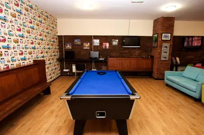a living room with a pool table in a room at International Inn in Liverpool