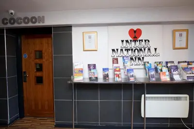 a room with a shelf with products on it at International Inn in Liverpool