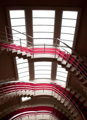 a spiral staircase in a building with windows at The Midland in Morecambe
