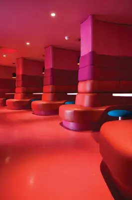 a red and purple room with red and purple chairs at The Midland in Morecambe