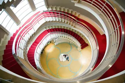 a red and white spiral staircase with two people at The Midland in Morecambe