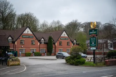 a building with a car parked in a parking lot at The Fernhurst by Greene King Inns in Blackburn