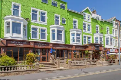 a green building on the side of a street at The Lawton in Blackpool