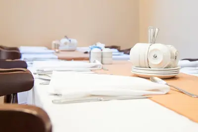 a row of desks with white plates and utensils at The Lawton in Blackpool