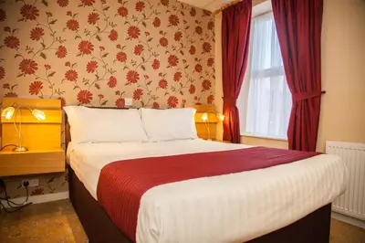 a hotel room with a bed and a window at The Lawton in Blackpool