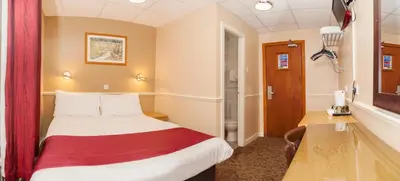 a hotel room with a bed and a desk at The Lawton in Blackpool