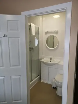 a bathroom with a shower and a toilet and a sink at The Lawton in Blackpool