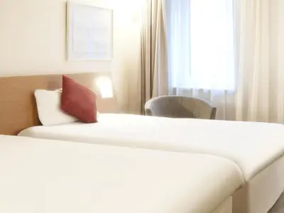a hotel room with a bed and a window at Novotel Liverpool Centre in Liverpool