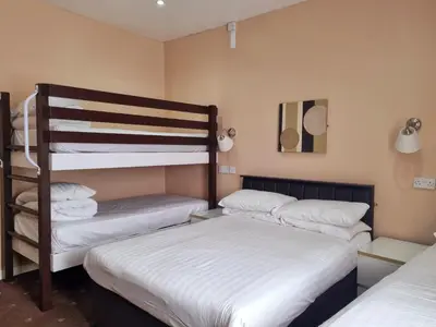 two bunk beds in a room with two beds at The Beechfield Hotel in Blackpool