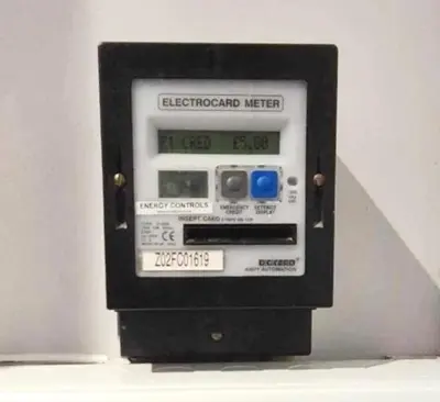 a electronic machine with a clock on the side of it at St Nicholas Holiday Apartments in Blackpool
