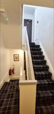a staircase in a building with a stair case at St Nicholas Holiday Apartments in Blackpool